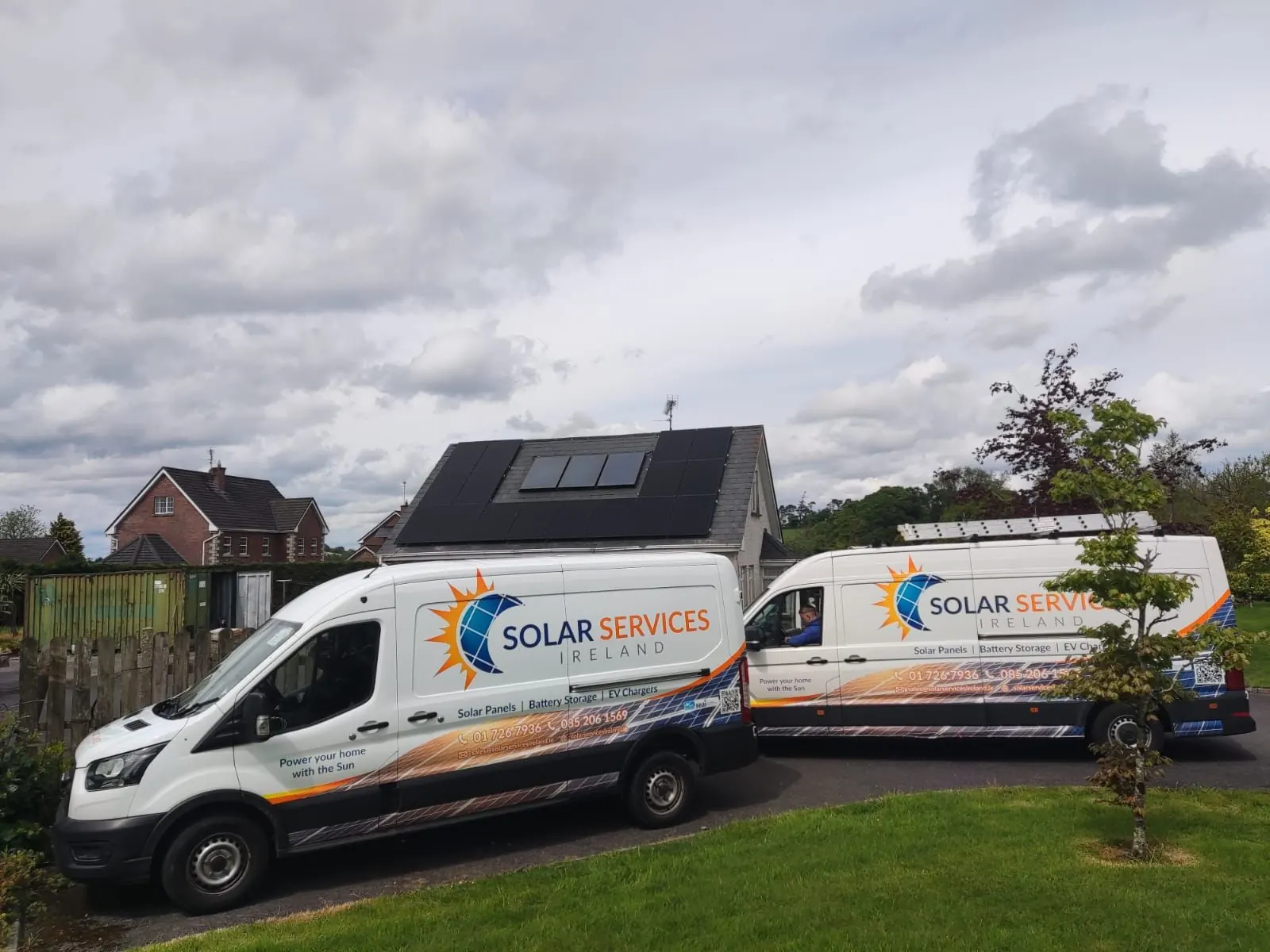 Bungalow with solar panels and Solar Services Ireland vans outside