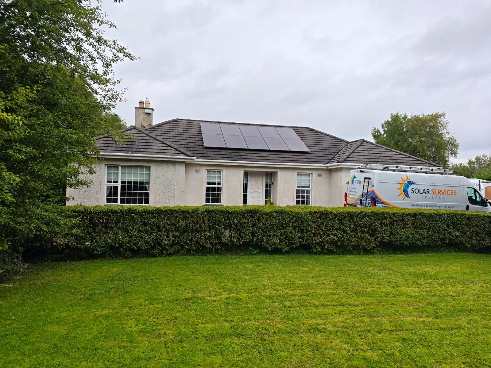 Bungalow with solar panels and a Solar Services Ireland van outside